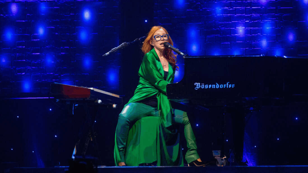 Tori Amos performing live on stage, showcasing her powerful musical presence.
